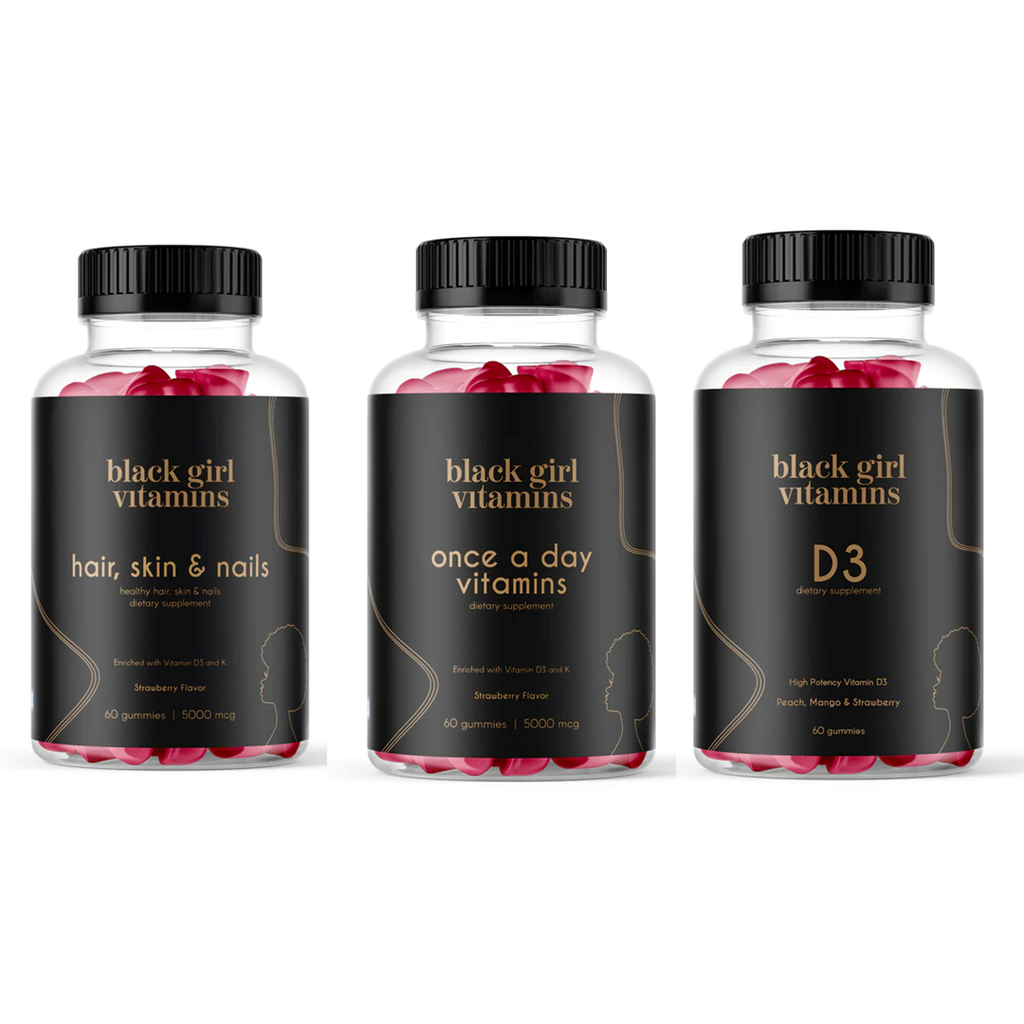 Three Black Girl Vitamins bottles: Hair, Skin & Nails; Once a Day Vitamins; D3 dietary supplements with flavors and quantities.